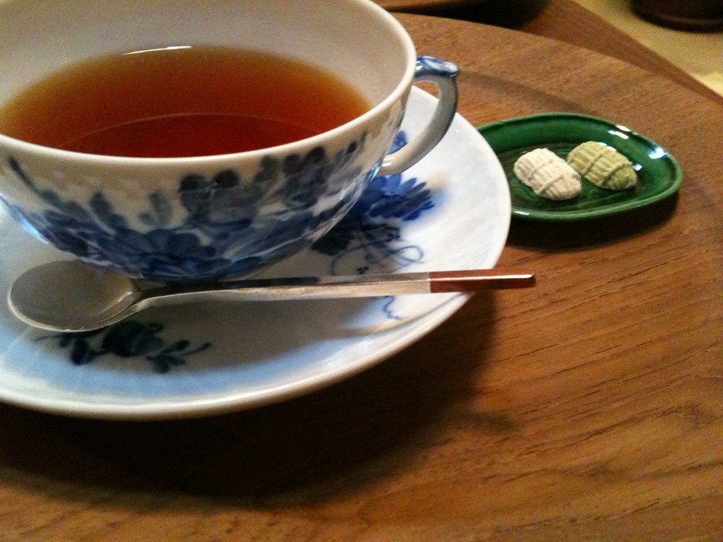 Cup of tea in a blue patterned china cup on a wooden table