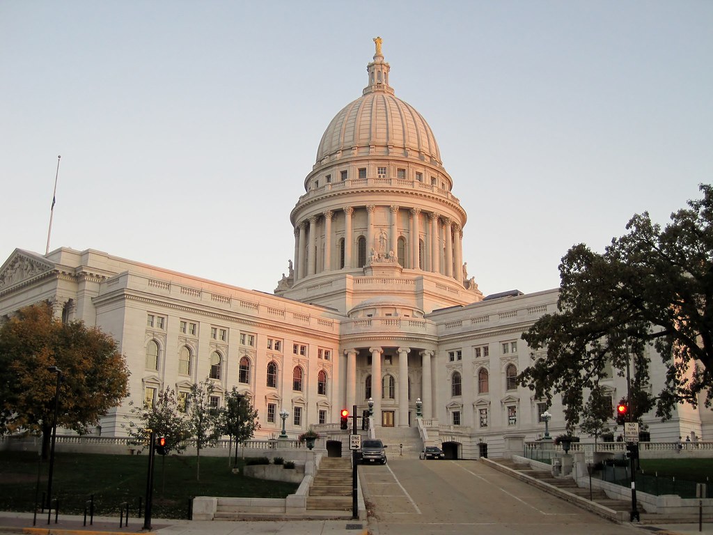 The white-domed Wisconsin State Capitol glowing in early evening light
